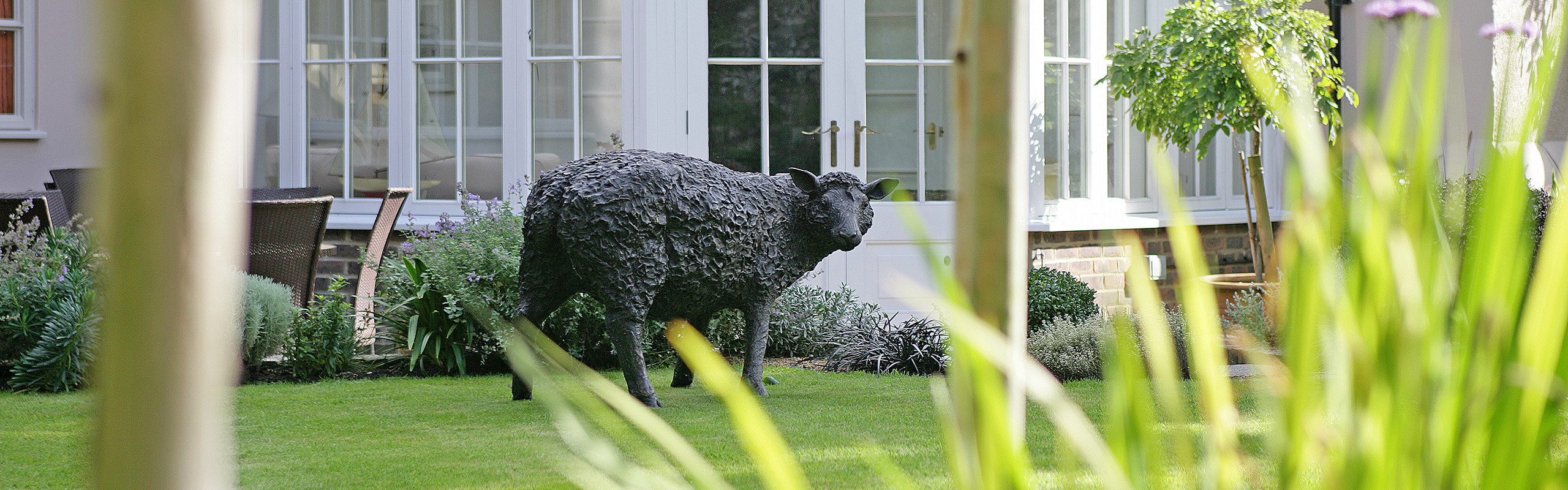 View of the garden of The Dene including sheep sculpture